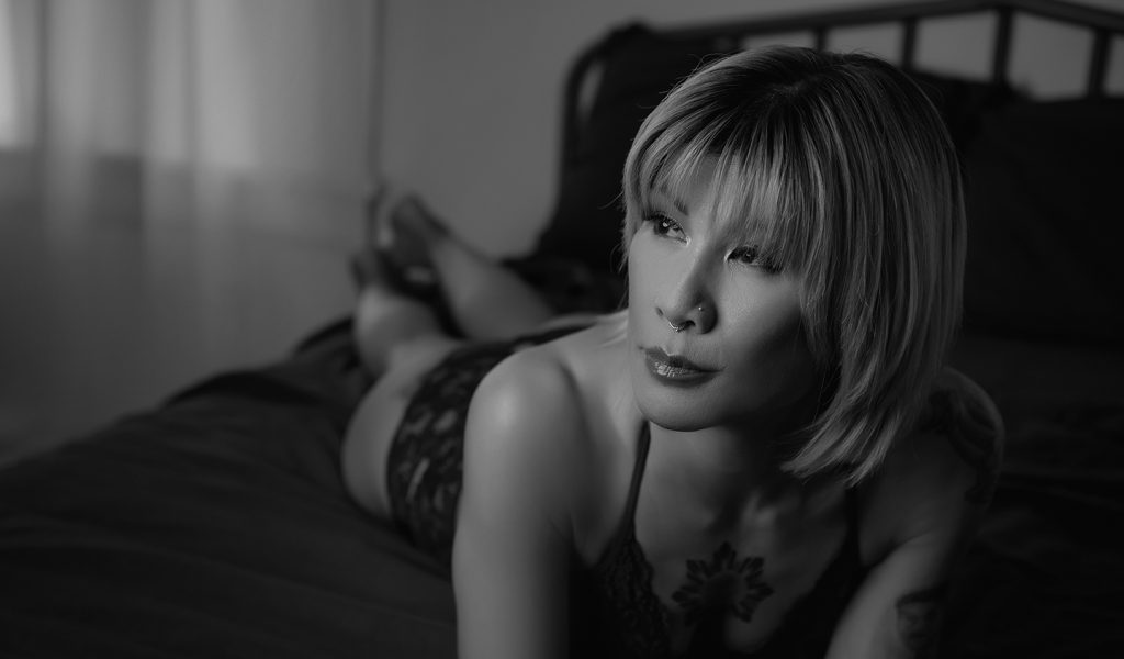 Love your body boudoir portrait capturing softness and confidence.